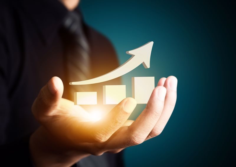 Hand,Holding,A,Rising,Arrow,,Representing,Business,Growth.